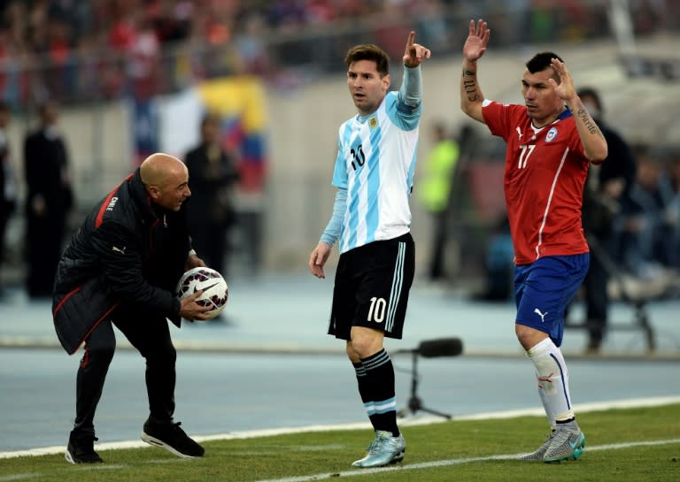 Argentina's Lionel Messi (C) and Chile's Gary Medel (R) gesture next to then Chile's coach Jorge Sampaoli during their 2015 Copa America final match