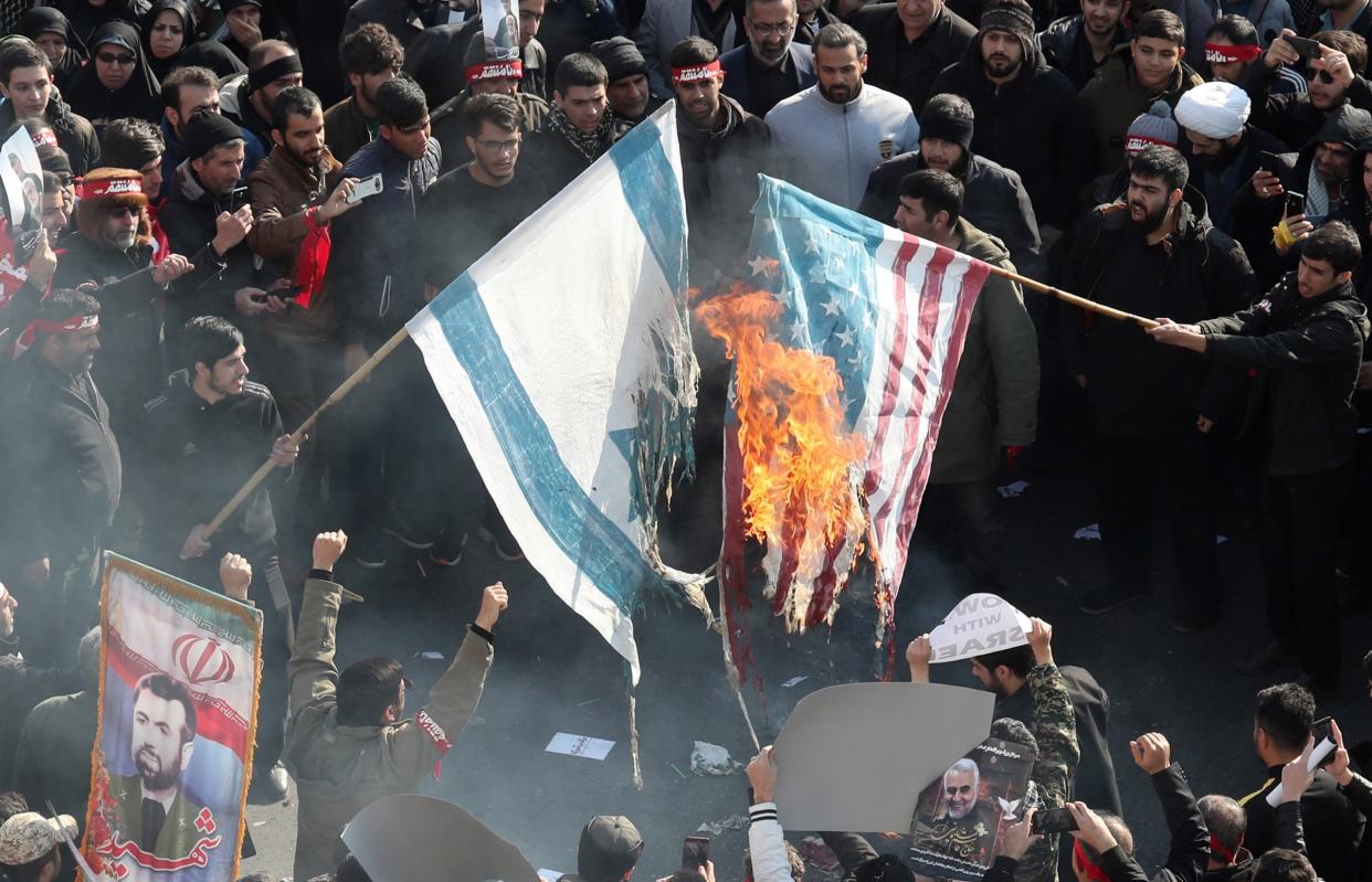 Iranians burn US and Israel flags during a funeral ceremony for slain commander of the Quds Force Qasem Soleimani: EPA