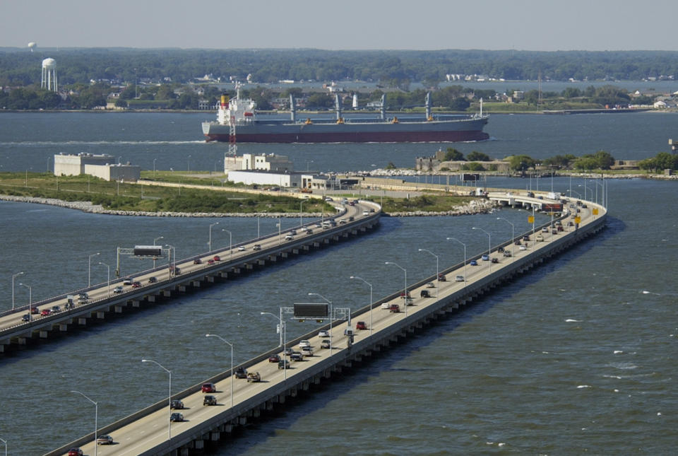 FILE - In this Sept. 16, 2003, file photo, a freighter heads out to sea as traffic backs up on the Hampton Roads Bridge-Tunnel in Norfolk, Va. Virginia officials announced plans Friday, Feb. 1, 2020. to create new habitat for about 25,000 seabirds after their nesting grounds were paved for the Hampton Roads Bridge-Tunnel expansion project, a case that highlighted weakened protections for birds under President Donald Trump. (AP Photo/Steve Helber, File)