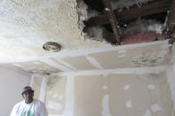 **HOLD FOR MOVEMENT WITH STORY BY JUAN LOZANO**Houston resident Lawrence Hester looks at a hole in the ceiling Thursday, January 16, 2020, of his daughter's bedroom that was caused by a leaky roof damaged during Hurricane Harvey in 2017. Hester said he was unable to get help from a city program created to fix homes damaged during Harvey and had to endure hazardous living conditions for more than two years. He turned to a local nonprofit to fix his home. The city program has finished rebuilding less than 70 homes since beginning in January 2019. (AP Photo/Juan Lozano)