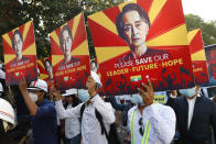 Engineers hold posters with an image of deposed Myanmar leader Aung San Suu Kyi as they stage an anti-coup protest march in Mandalay, Myanmar, Monday, Feb. 15, 2021. The hopes of building a robust democracy in Myanmar were shattered when the powerful military toppled the elected government of Aung San Suu Kyi and her National League for Democracy party in the Feb. 1 coup. (AP Photo)