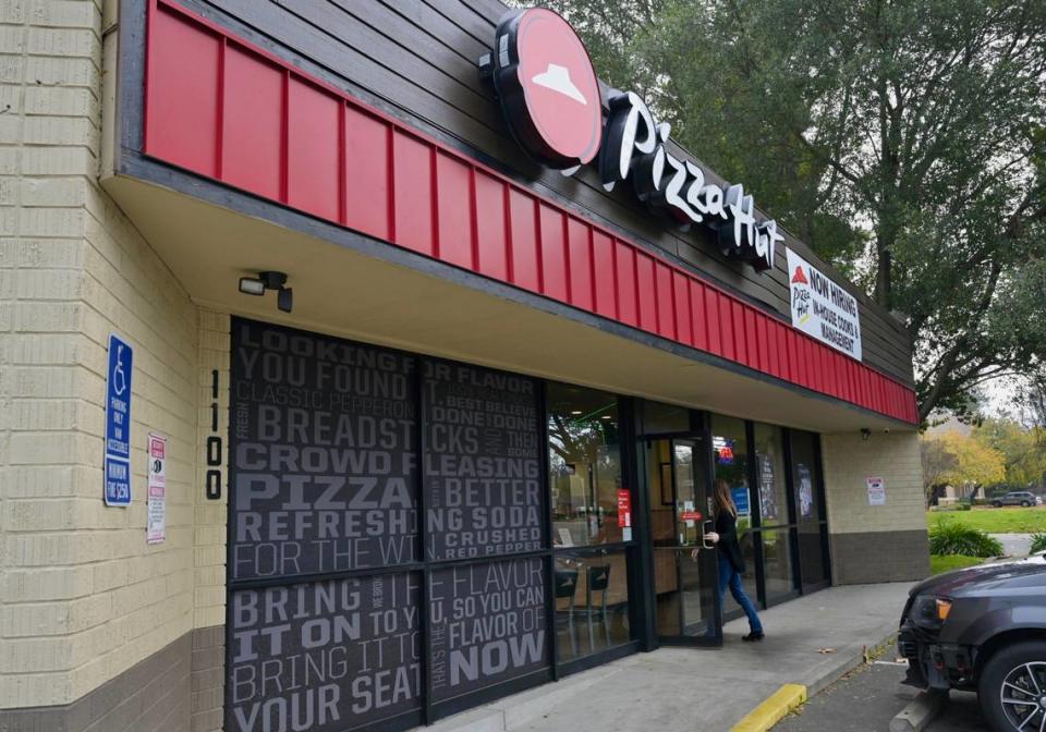 A customer enters the Pizza Hut at 1100 Fulton Ave. in Arden Arcade on Wednesday, Dec. 27, 2023. The owner of the Sacramento County franchise is laying off delivery drivers to avoid paying the $20 an hour rate required by a new state law for fast-food workers. Hector Amezcua /hamezcua@sacbee.com