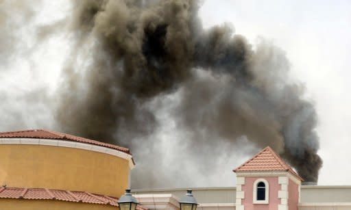 Smoke rises from the Villaggio Mall in Doha after a fire broke out on May 28. Firefighters in Qatar told Wednesday how they tried to rescue 13 children trapped by the blaze in a mall nursery but by the time they reached the toddlers most were dead, huddled in the arms of two fellow firemen who perished during the rescue attempt