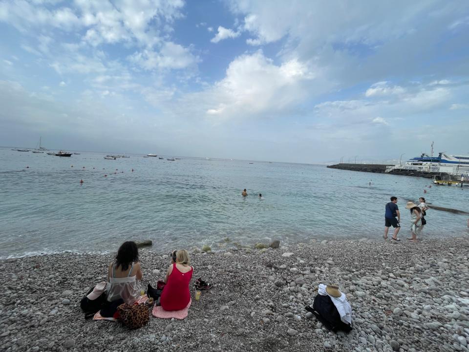 Marina Grande with rocky sand and light blue waters under a blue sky