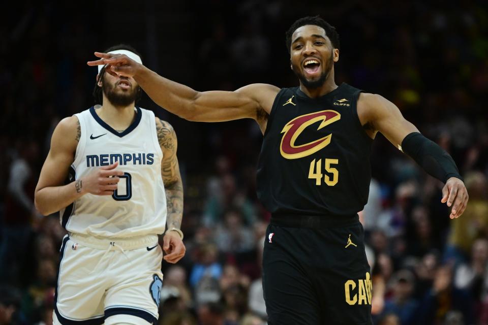 Cleveland Cavaliers guard Donovan Mitchell (45) celebrates after hitting a 3-pointer as Memphis Grizzlies forward Timmy Allen (0) looks on Wednesday in Cleveland.