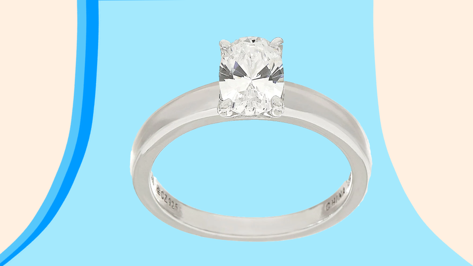 This stunning sterling silver ring has a cubic zirconia oval-shaped gemstone center.