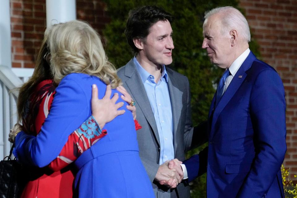 Trudeau and wife Sophie Gregoire Trudeau (left) greet the Bidens in Ottawa last night (AP)