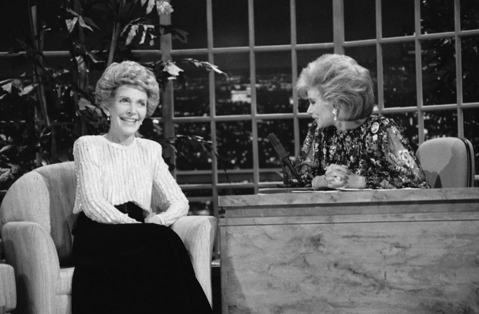 FILE - In this Oct. 30, 1986 file photo, talk show host Joan Rivers, right, talks with guest, first lady Nancy Reagan, during her appearance on "The Late Show Starring Joan Rivers," on Fox TV. The role of female talk-show hosts in late-night TV network history, all 50-plus years of it, can be summed up in two words: Joan Rivers. It takes just another two _ Arsenio Hall _ to do the same for minorities. There's no indication that's going to change in the latest round of musical chairs involving "Tonight" and "Late Night." (AP Photo, Reed Saxon, File)