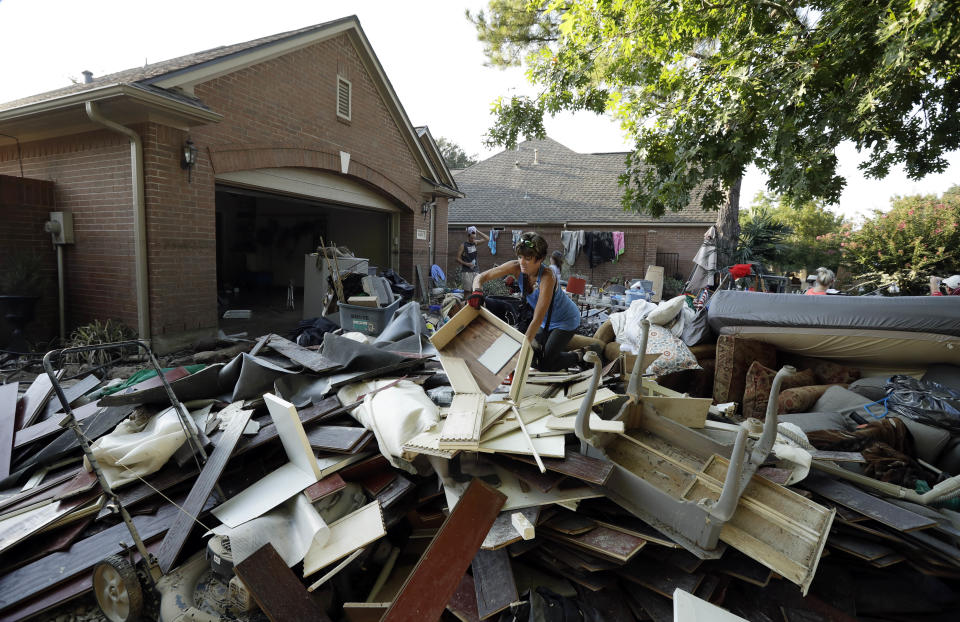 <p>Volunteers from Performance Contractors help co-worker Cornell Beasley recover from damage to his home after torrential rains caused widespread flooding during Hurricane and Tropical Storm Harvey on September 1, 2017 in Houston, Texas. Harvey, which made landfall north of Corpus Christi on August 25, dumped around 50 inches of rain in and around areas of Houston and Southeast Texas. (Photo: Scott Olson/Getty Images) </p>