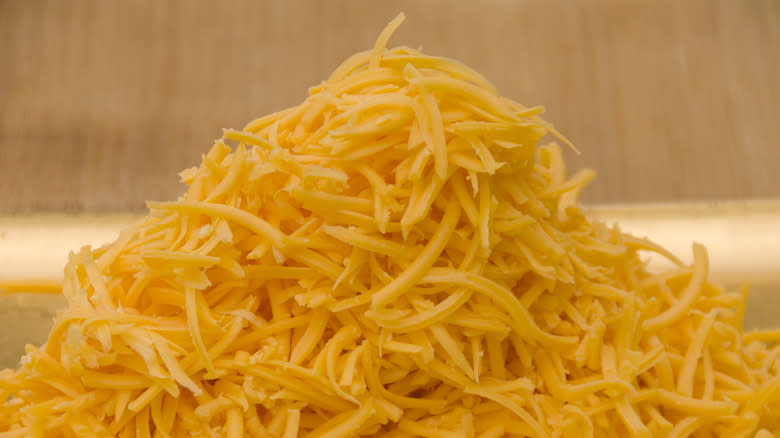 pile of grated cheddar cheese