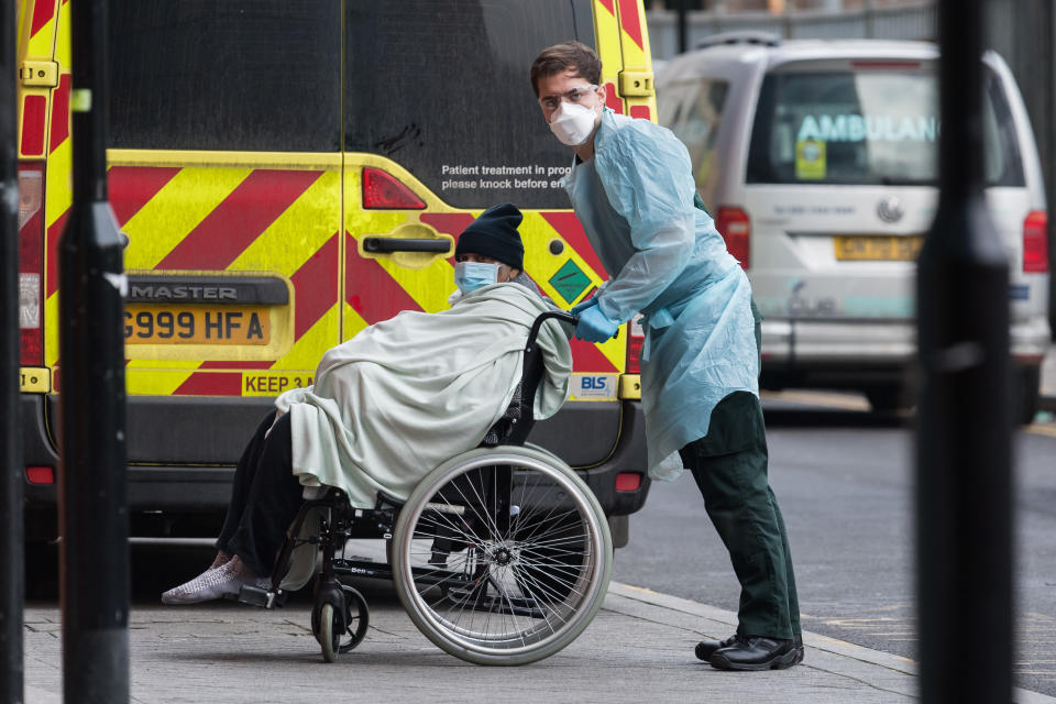 Paramedic transports a patient  from the ambulance to the emergency department at the the Royal London Hospital, on 15 January, 2021 in London, England. Hospitals across the country are dealing with an ongoing rise in Covid-19 cases, providing care to more than 35,000 people, which is around 50% more than at the peak of the virus in spring, with fears that hospitals in London may be overwhelmed within two weeks unless the current infection rate falls. (Photo by WIktor Szymanowicz/NurPhoto via Getty Images)