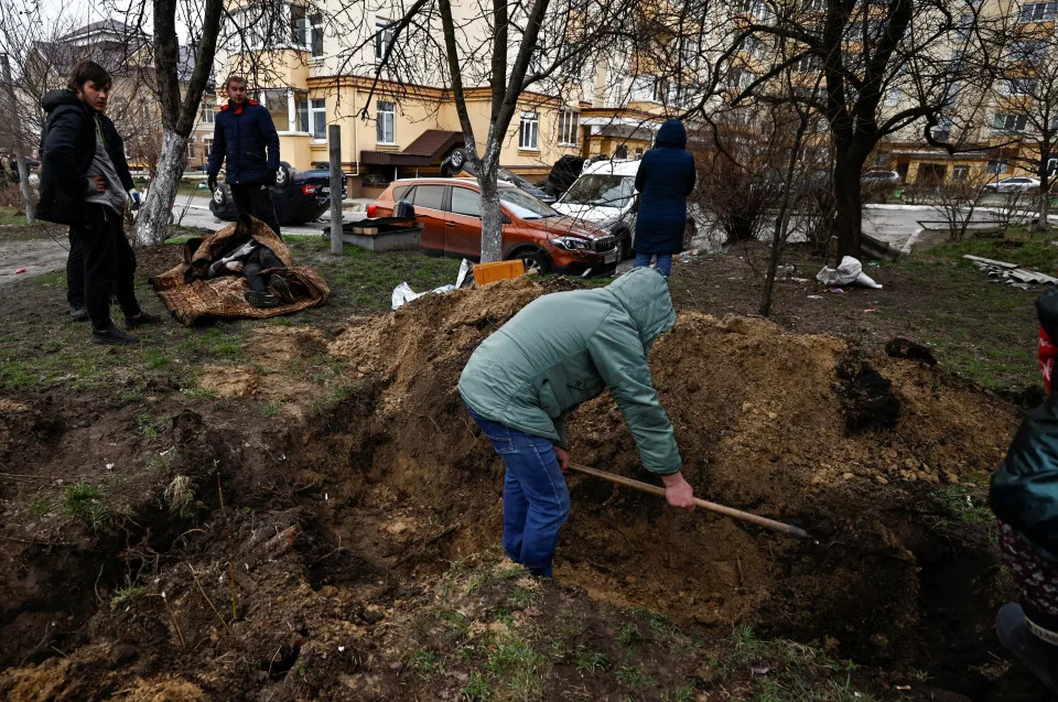 People dig graves in Bucha, Ukraine, on April 5, 2022.
