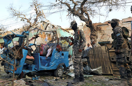 Somali security forces assess the damage at the scene of an explosion outside Weheliye Hotel in Maka al Mukarama street in Mogadishu, Somalia March 22, 2018. REUTERS/Feisal Omar