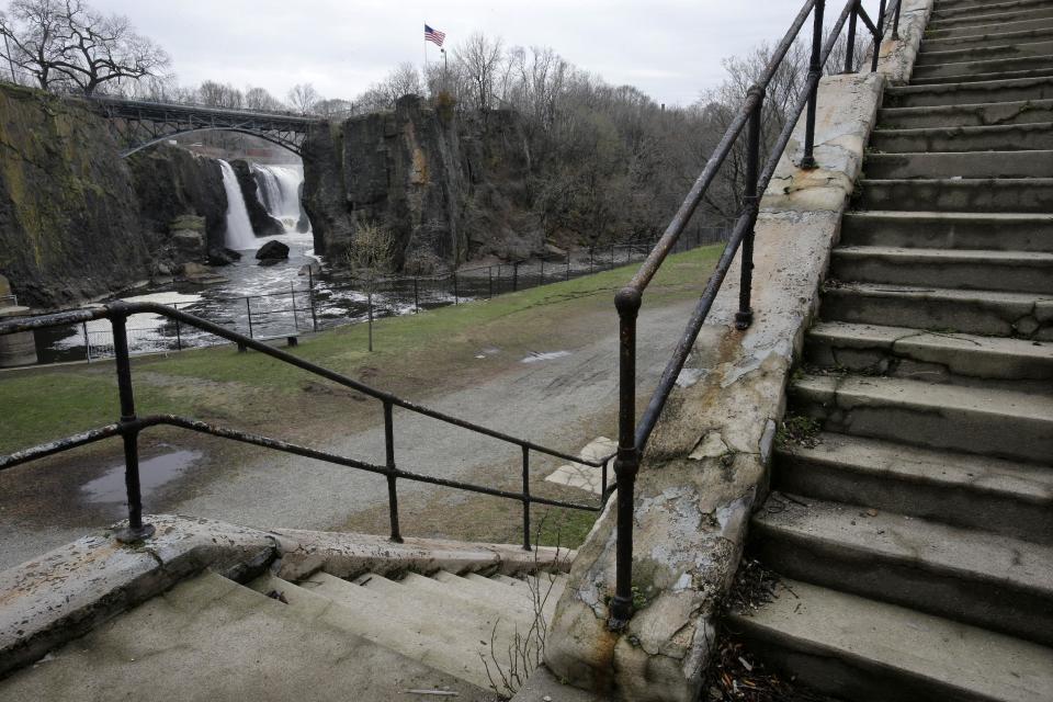 This Saturday, April 13, 2013 photo shows a crumbling staircase at the Great Falls park are in Paterson, N.J. Water from the Passaic River rushes over at a rate of 2 billion gallons per day, making it the second largest waterfall east of the Mississippi River, by volume, next to Niagara Falls. (AP Photo/Mel Evans)