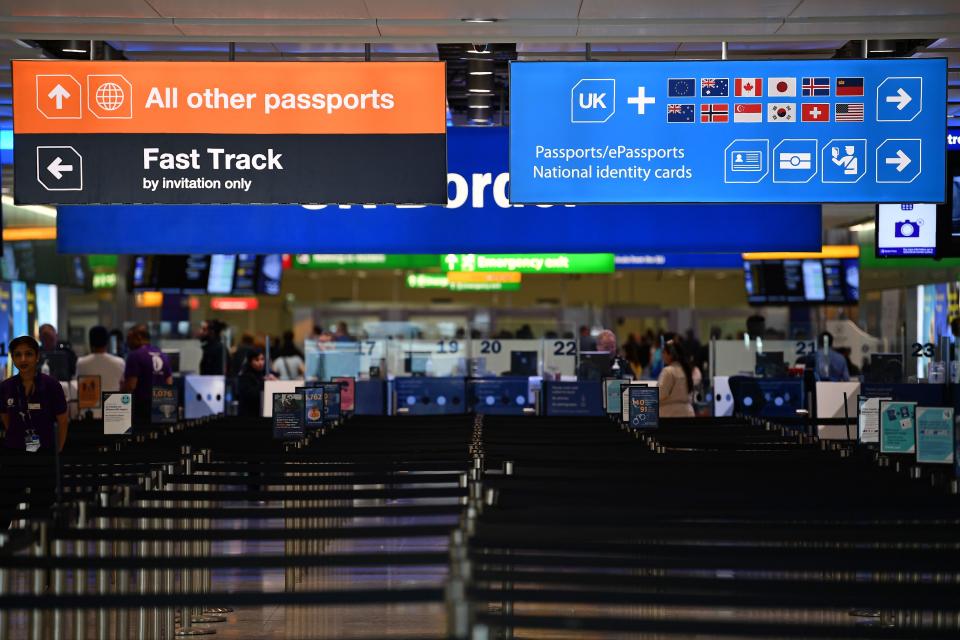 Passport signs directing passengers, are pictured at the passport control in Arrivals in Terminal 2 at Heathrow Airport in London on July 16, 2019 (Photo by Daniel LEAL-OLIVAS / AFP)        (Photo credit should read DANIEL LEAL-OLIVAS/AFP/Getty Images)