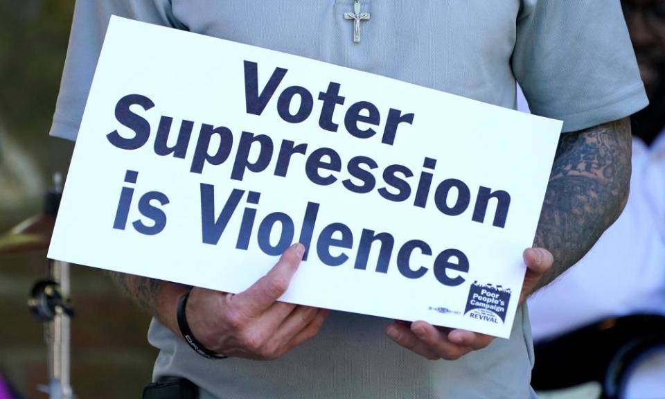 A person previously convicted of a felony felon holds a sign about voter suppression during a Poor People’s Campaign assembly in Jackson, Mississippi, in 2021.