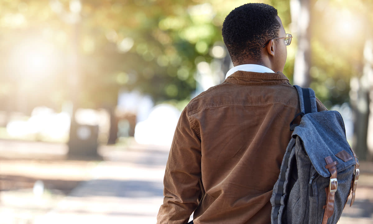 This is a photo of a college student walking outside on campus.