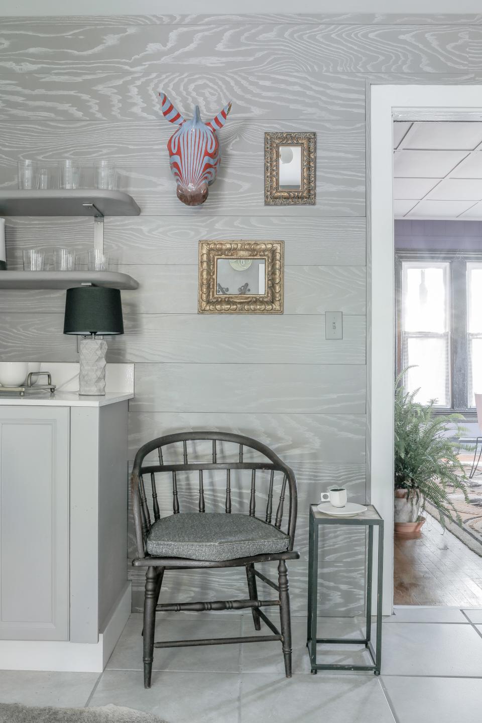 AFTER: Incorporating accessories like a table lamp and mirrors in the kitchen decor make the space feel less utilitarian and more intimate. The cabinet and wall paint color is Sherwin-Williams Proper Gray and the darker accent color used is Sherwin-Williams Mink.