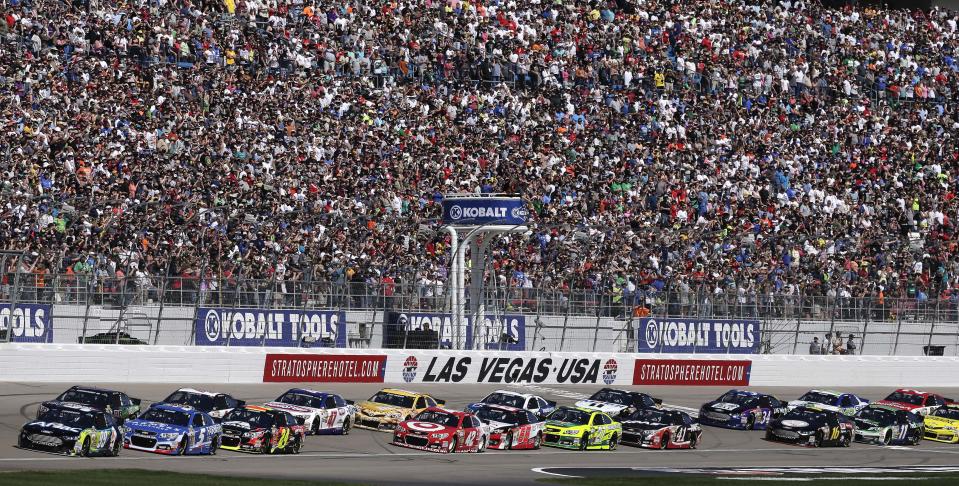 Drivers accelerate at the start of a NASCAR Sprint Cup Series auto race on Sunday, March 9, 2014, in Las Vegas. (AP Photo/Julie Jacobson)