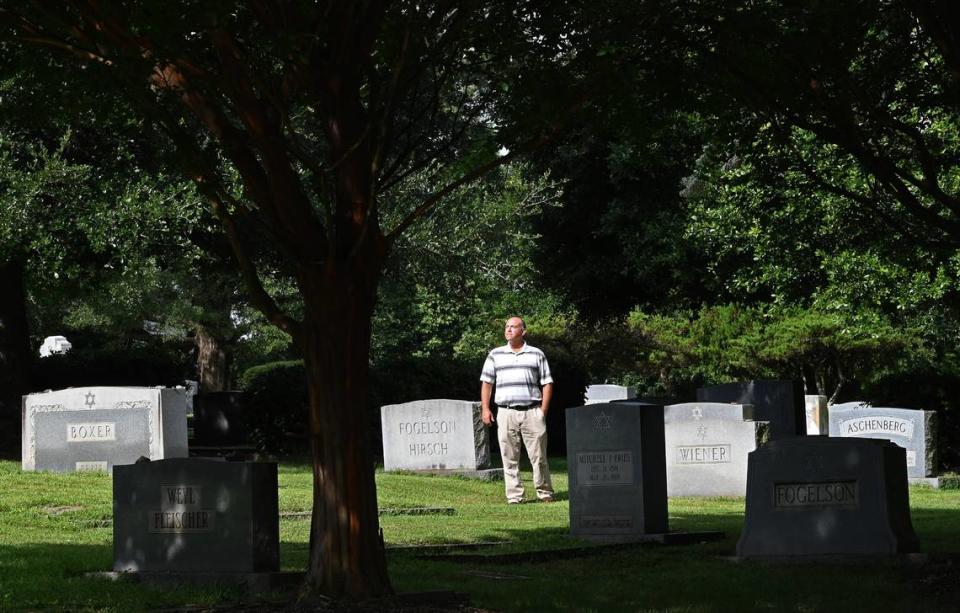 Brian Yesowitch the Hilbert Fuerstman Historical Chairperson of the Hebrew Cemetery stands amongst the headstones on Friday, August 11, 2023. The Hebrew Cemetery of Greater Charlotte has eyes on expanding and providing burial space for the next 150 years, but it’s worried about the potential sale of an adjacent school to the highest bidder for apartments or a mixed-use development. The cemetery is one of the more prominent Jewish cemeteries in North Carolina.