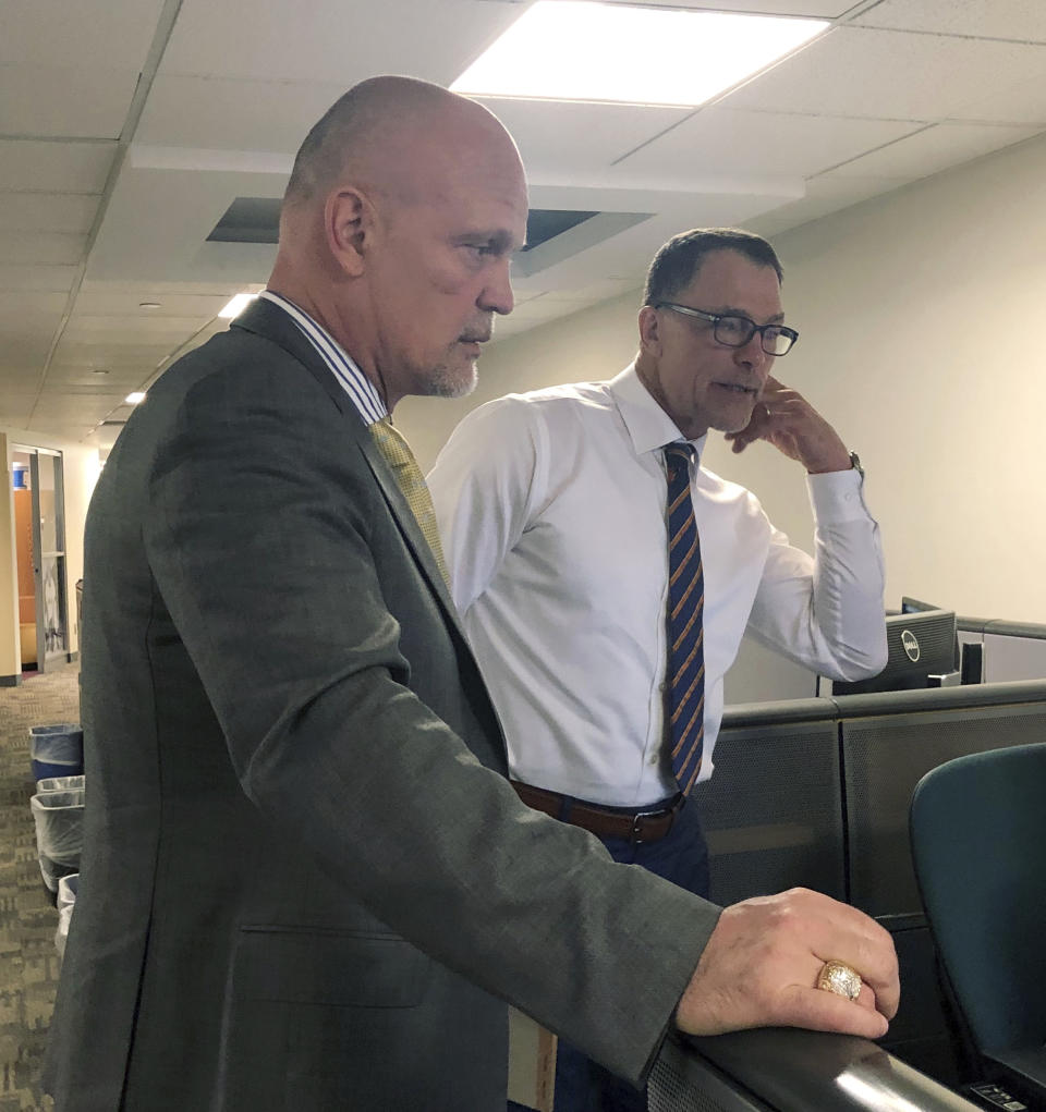 Former New Jersey Devils defensemen Ken Daneyko, left, and Scott Stevens break down a play in an office before an appearance on NHL Network in Secaucus, N.J., Monday, April 29, 2019. After developing on-ice chemistry over 12 years, doing it on the air is a new challenge. (AP Photo/Stephen Whyno)