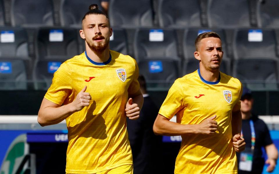 Romania's Radu Dragusin and Nicusor Bancu warm up ahead of the match against Slovakia.