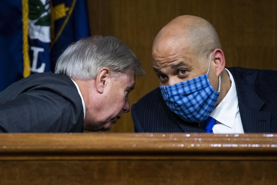 Chairman Lindsey Graham, R-S.C., left, talks with Sen. Cory Booker, D-N.J., during a Senate Judiciary Committee hearing on police use of force and community relations on on Capitol Hill, Tuesday, June 16, 2020 in Washington. (Tom Williams/CQ Roll Call/Pool via AP)