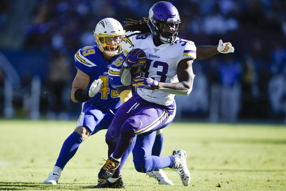FILE - In this Sunday, Dec. 15, 2019, file photo, Minnesota Vikings running back Dalvin Cook runs with the ball during the first half of an NFL football game against the Los Angeles Chargers in Carson, Calif. The Vikings are expecting Cook to report on time for training camp, coach Mike Zimmer said Saturday, July 25, 2020. Cook has begun the final year of his rookie contract and took a break from the virtual offseason program in June, seeking a new deal. (AP Photo/Kelvin Kuo, File)