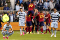 Real Salt Lake players celebrate after their MLS soccer match against Sporting Kansas City Sunday, Nov. 28, 2021, in Kansas City, Kan. Real Salt Lake won 2-1.(AP Photo/Charlie Riedel)