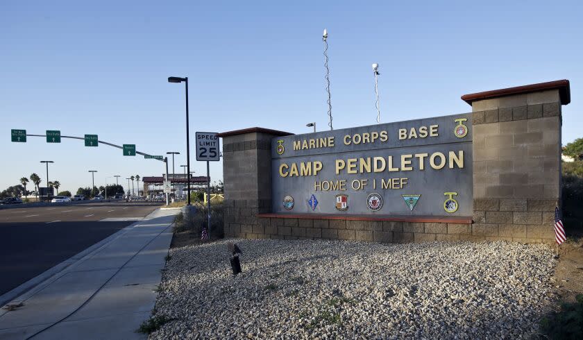 FILE - This Nov. 13, 2013 file photo shows the main gate of Camp Pendleton Marine Base at Camp Pendleton, Calif. A human smuggling investigation by the military led to the arrest of 16 Marines Thursday, July 25, 2019 while carrying out a battalion formation at California's Camp Pendleton, a base about an hour's drive from the U.S.-Mexico border. (AP Photo/Lenny Ignelzi, File)