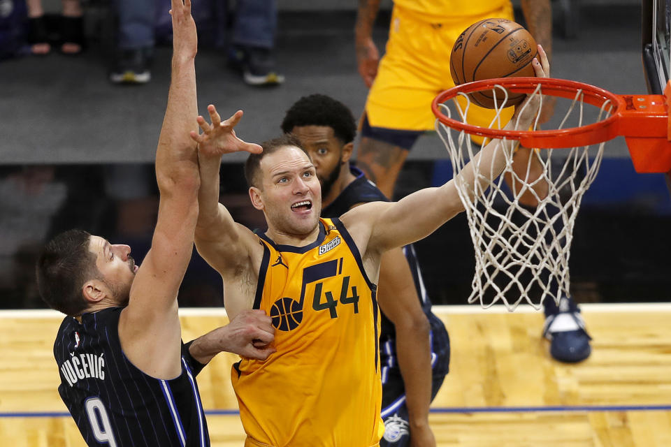 Utah Jazz forward Bojan Bogdanovic (44) is fouled by Orlando Magic center Nikola Vucevic (9) in the second half during an NBA basketball game, Saturday Feb. 27, 2021, in Orlando, Fla. (AP Photo/Joe Skipper)