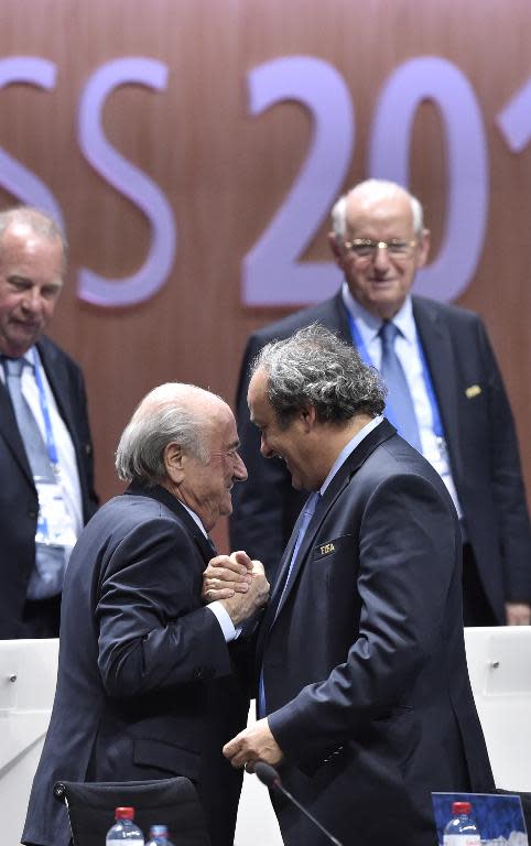 FIFA president Sepp Blatter (foreground left) shakes hands with UEFA president Michel Platini