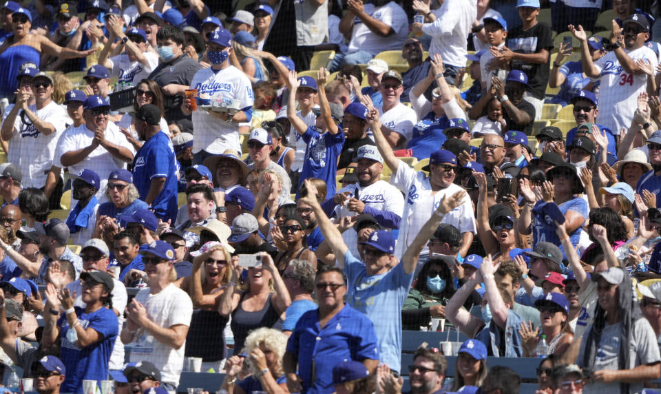 Los Angeles, CA - October 03:  Los Angeles Dodgers fans celebrates after Trea Turner #6 of the Los Angeles Dodgers hit a grand slam against the Milwaukee Brewers in the fifth inning of a baseball game at Dodger Stadium in Los Angeles on Sunday, October 3, 2021. (Photo by Keith Birmingham/MediaNews Group/Pasadena Star-News via Getty Images)