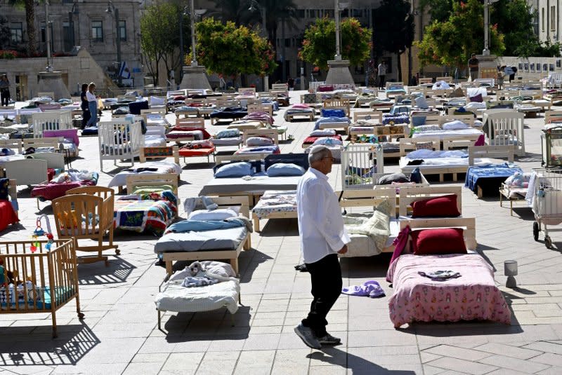 People view an installation called "Empty Beds" symbolizing the 230 empty beds of Israeli hostages held by Hamas in Gaza on Monday. Photo by Debbie Hill/ UPI