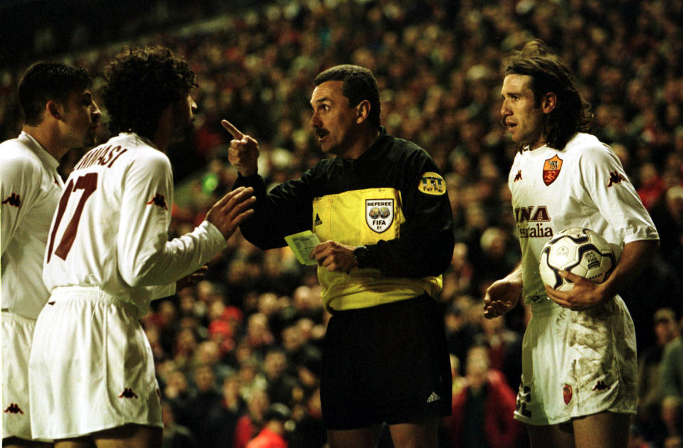 Roma players argue with Jose Garcia-Aranda after his phantom penalty call