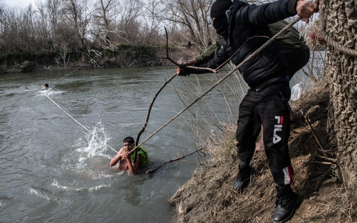 Migrants are rescued from an island in the middle of the Evros river while trying to cross from Turkey to Greece, March 2020 - Getty