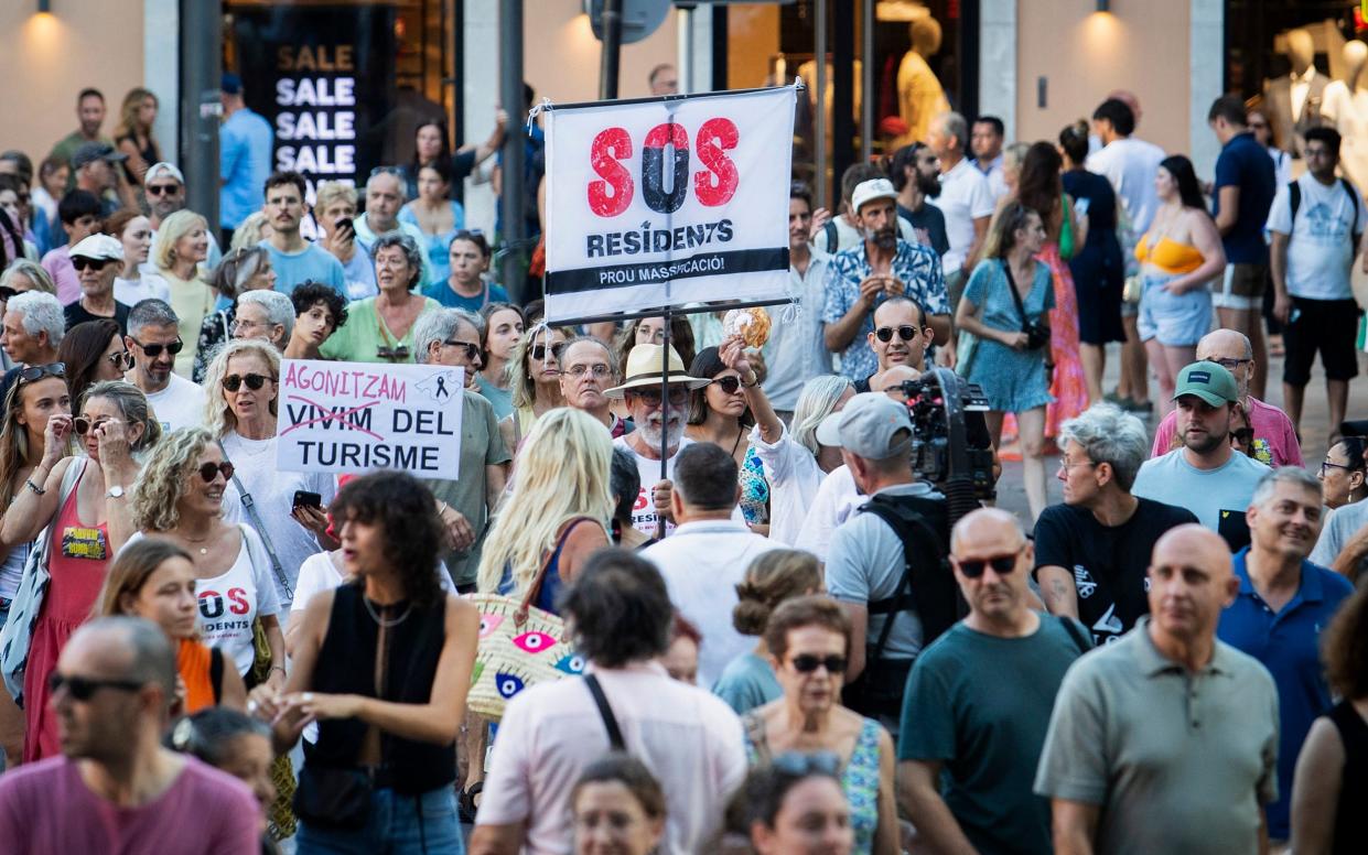 Protesters hold a banner which reads as 'SOS residents