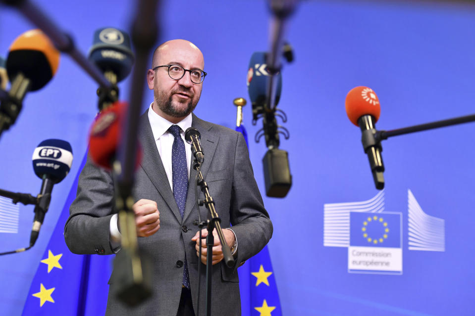 FILE - In this June 24, 2018 file photo, Belgian Prime Minister Charles Michel speaks with the media at the conclusion of an informal EU summit on migration at EU headquarters in Brussels. Belgium's government crisis eased somewhat on Wednesday after the biggest coalition partner said it would remain in the government despite its opposition to an U.N. migration pact that the others back. (AP Photo/Geert Vanden Wijngaert)