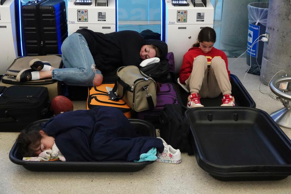 Travelers are left stranded at Fort Lauderdale Hollywood airport, Thursday, April 13, 2023 in Fort Lauderdale, Fla. Nearly a foot of rain fell in a matter of hours in Fort Lauderdale – causing widespread flooding, the closure of the city’s airport, all public schools and the suspension of high-speed commuter rail service. (Joe Cavaretta /South Florida Sun-Sentinel via AP)