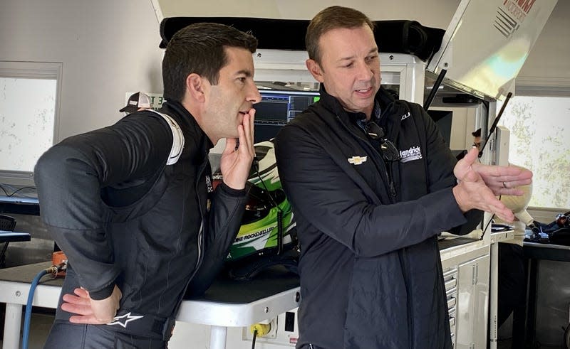 Chad Knaus using his hand to explain something to Mike Rockenfeller.