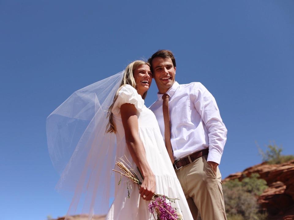 A woman and a man getting married and smiling.
