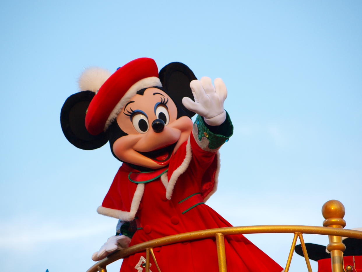 Tokyo, Japan: Minnie Mouse in the red coat waving her hand in daytime Parade at Tokyo-Disneyland, Tokyo, Japan.
