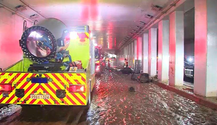 A South Korean emergency services vehicle is seen inside a highway underpass tunnel that was inundated during flash flooding, leaving 10 vehicles trapped and killing at least 13 people, in Cheongju, south of Seoul, South Korea, amid clean-up and recovery efforts on July 17, 2023. / Credit: REuters/KOREA POOL