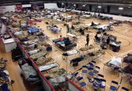 Cots litter the gym floor at an evacuee reception centre set up and operated by the regional municipality of Wood Buffalo in Anzac, Alta., on Wednesday, May 4, 2016. THE CANADIAN PRESS/Greg Halinda