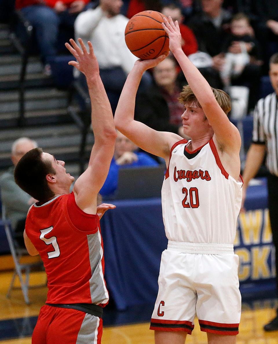 Crestview High School's Justice Thompson (20) shoots against Huron High School's Dylan Hohler (5) during their Division III district semifinal high school boys basketball game at Norwalk High School Wednesday, March 1, 2023. TOM E. PUSKAR/ASHLAND TIMES-GAZETTE