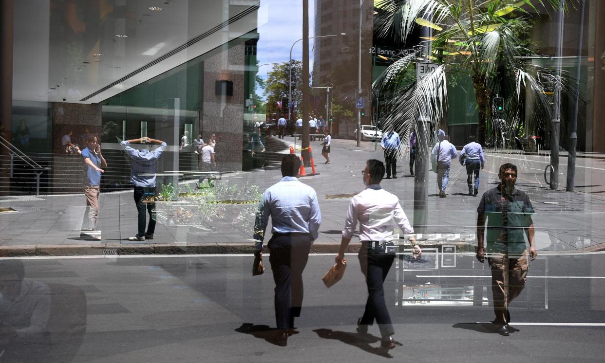 <span>Office workers reflected in a Sydney CBD window. An RBA cash rate cut appears a little less likely.</span><span>Photograph: Dan Himbrechts/AAP</span>