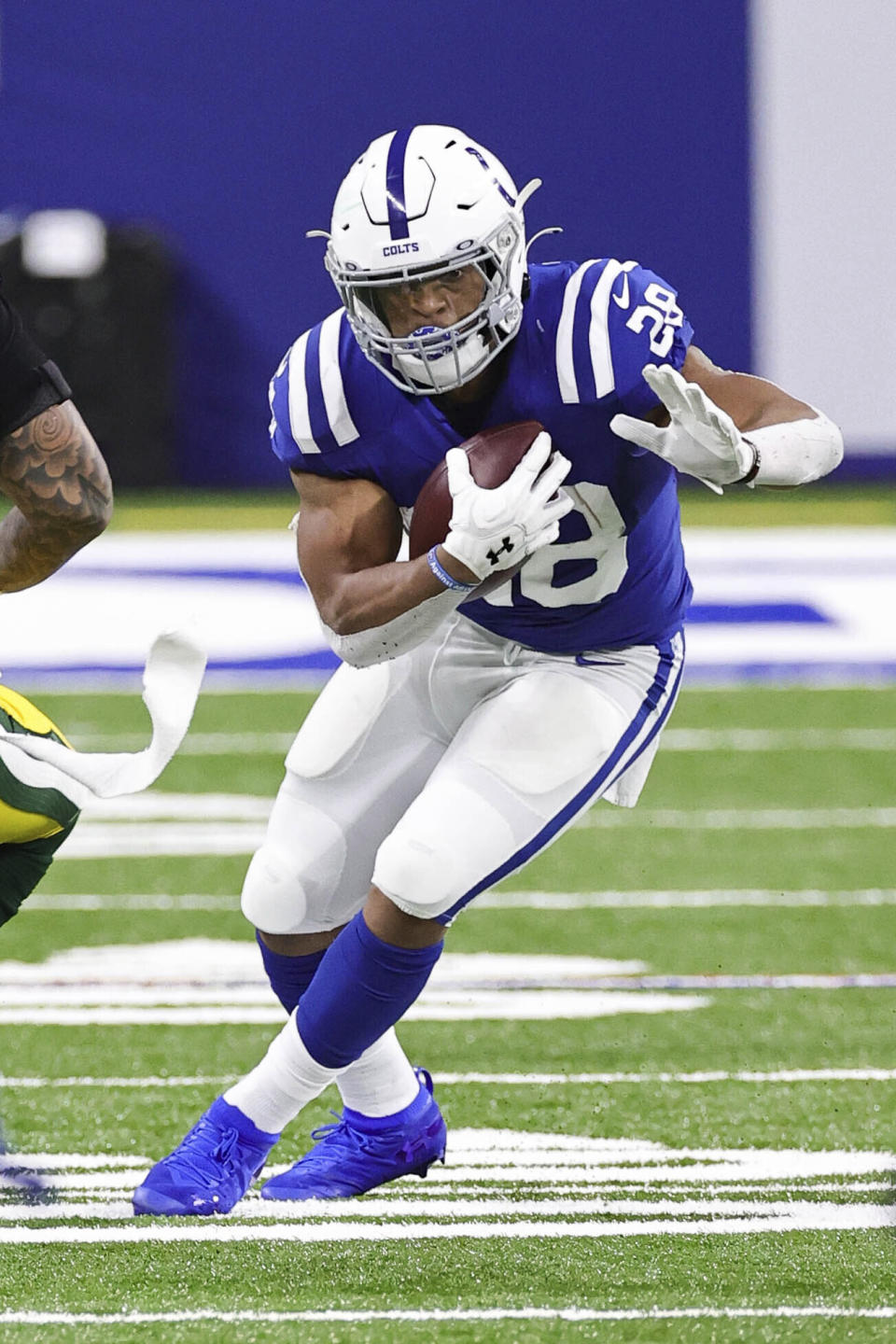 Indianapolis Colts running back Jonathan Taylor (28) carries the ball in an NFL game against the Green Bay Packers, Sunday, Nov. 22, 2020 in Indianapolis. The Colts defeated the Packers 34-31. (Margaret Bowles via AP)