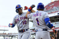 New York Mets' Francisco Lindor, left, celebrates with Jeff McNeil after hitting a solo home run during the fifth inning of a baseball game against the Cincinnati Reds in Cincinnati, Monday, July 4, 2022. (AP Photo/Aaron Doster)