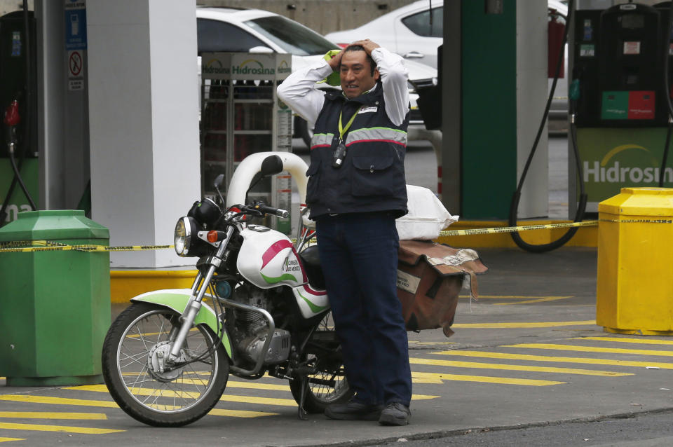 A postal worker whose motorcycle ran out of gas stands at a closed gas station in Mexico City, Monday, Jan. 14, 2019. Mexico President Andres Manuel Lopez Obrador has vowed to get the upper hand on fuel thieves and is trying to choke off their supply by taking several major pipelines off line. However, tanker trucks used to deliver the fuel couldn’t distribute fuel at the same levels as the pipelines, triggering shortages and panic buying. (AP Photo/Marco Ugarte)