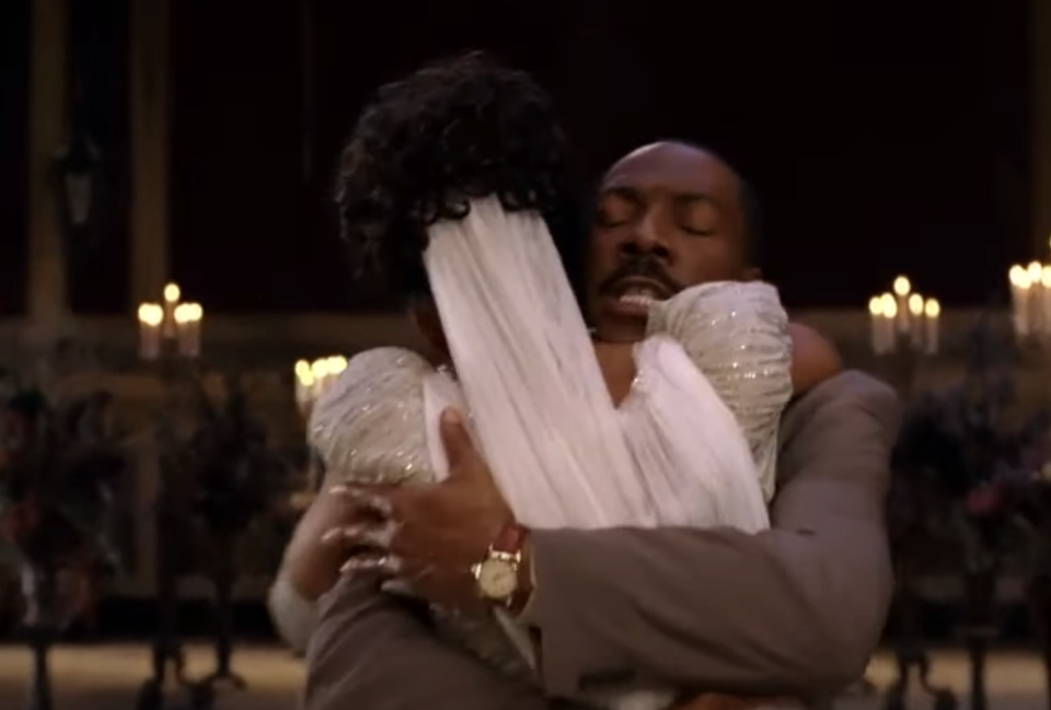 Eddie Murphy and Shari Headley hugging in a scene from "Coming to America"